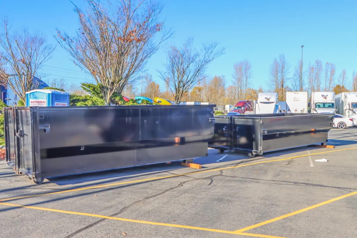 Professional dumpster rental service with roll-off container on residential driveway in Purcellville